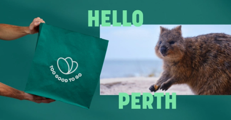 a person is holding a green bag that says too good to go