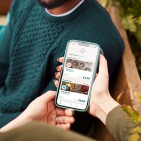 a person is holding a cell phone in their hand .