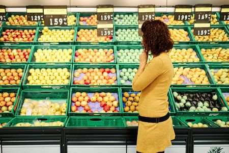 Shopper comparing grocery prices