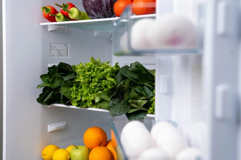 the inside of a refrigerator filled with fruits and vegetables .