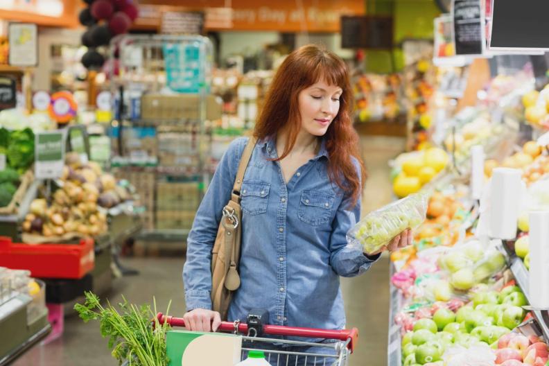 woman grocery shopping for deals