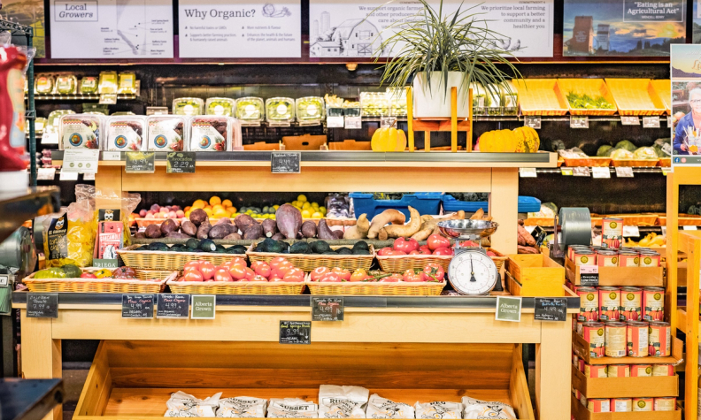 a sign in a grocery store explains why organic
