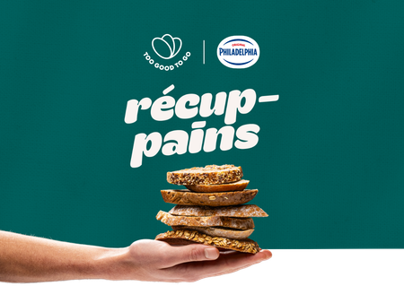 a hand holding a stack of slices of bread with a philadelphia logo in the background