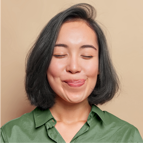 a woman in a green shirt is sticking her tongue out