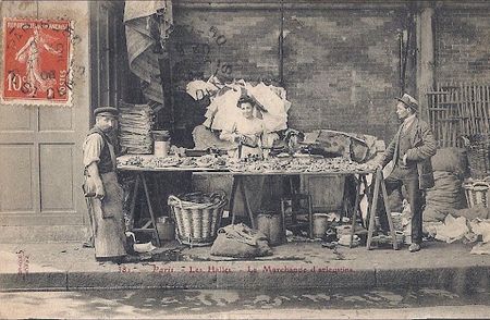 Vintage photo of a shellfish vendor and two men at a market stall in Les Halles, Paris.