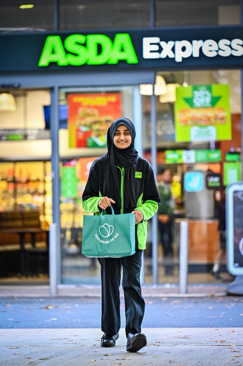 a woman outside Asda Express carrying a Too Good To Go bag