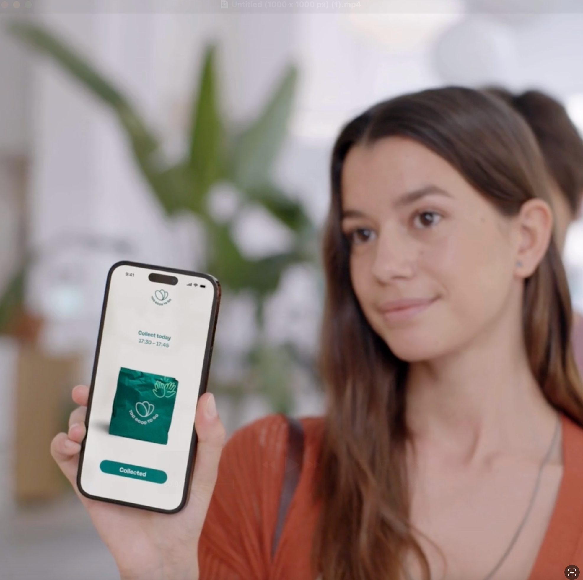 A women showing an order confirmation from the Too Good To Go App