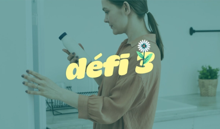 a woman holds a bottle in front of a sign that says défi 3