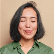 a woman in a green shirt is sticking her tongue out