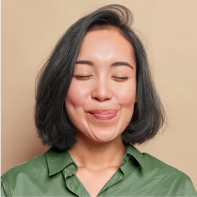 a woman in a green shirt is sticking her tongue out