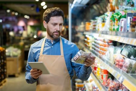 Grocery employee checking perishable inventory