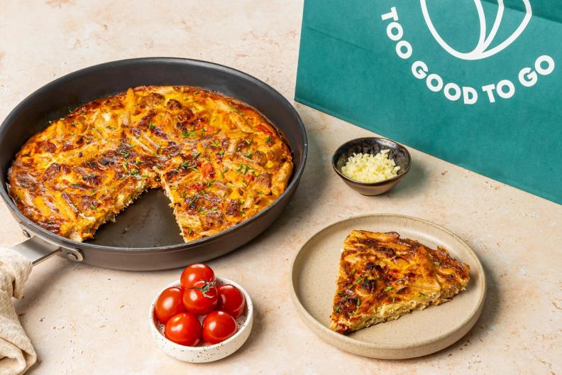 leftover pasta frittata recipe image with a Too Good To Go bag featured.