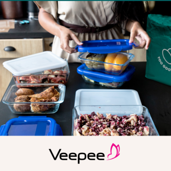 a woman is putting food in containers with the word veepee on the bottom