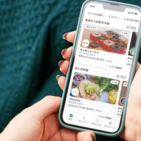 a person is holding a cell phone in their hand .