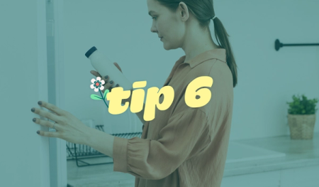 a woman is holding a bottle in front of a sign that says tip 6