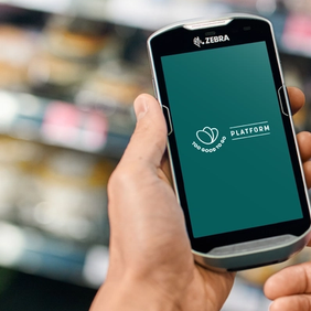 a person is holding a cell phone in a grocery store .