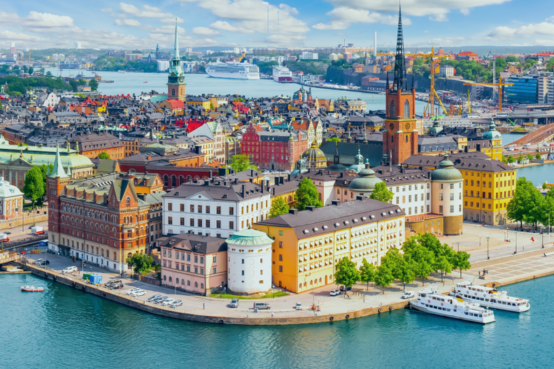 a city with a lot of buildings and boats in the water