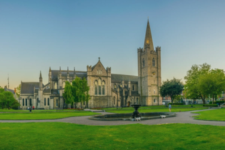 a large church with a steeple and a fountain in front of it