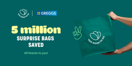 a person holding a green bag that says 5 million surprise bags saved