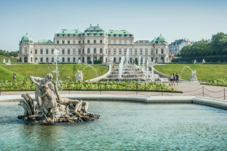 a large building with a fountain in front of it