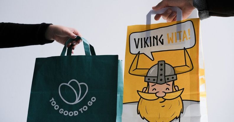 a person is holding a bag with a picture of a viking on it .