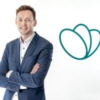 a man in a suit is standing with his arms crossed in front of TGTG logo