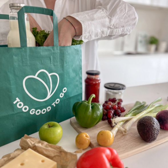 a green bag that says too good to go on it