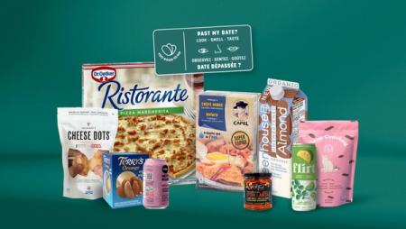 An assortment of packaged food and drink products, including pizza, snacks, and drinks, alongside a sign reading "Past my date? Look - Smell - Taste."