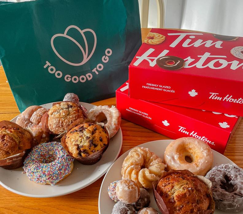 a bag that says too good to go is next to a box of tim hortons