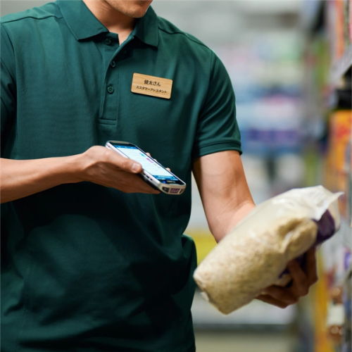 Supermarket worker printing a label from a portable printer
