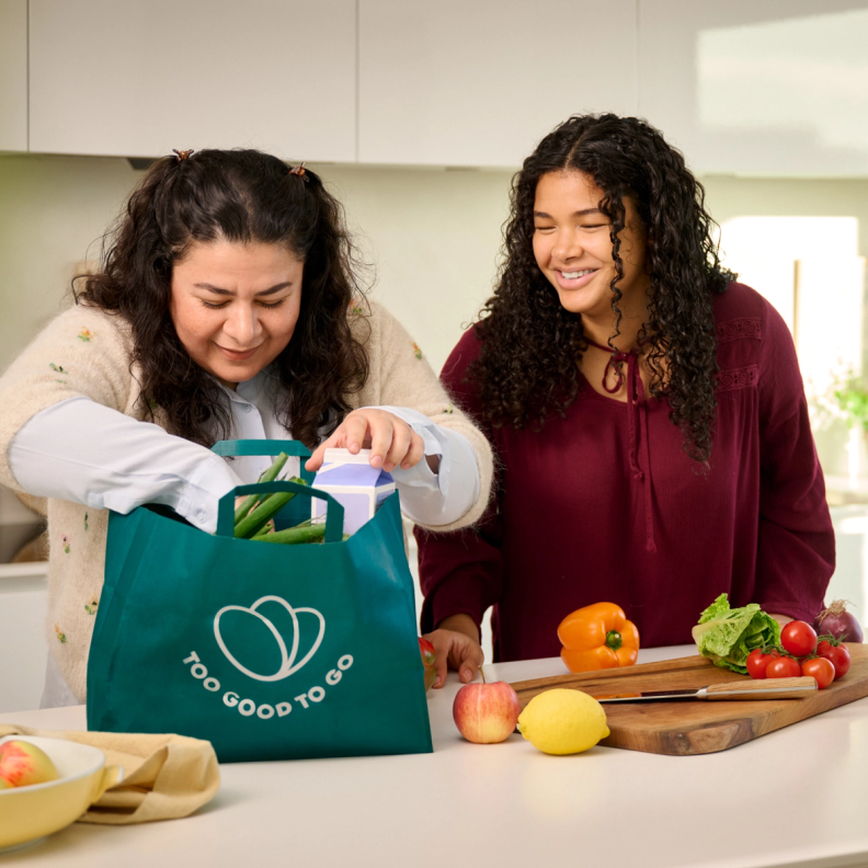 Mother and daughter emptying a grocery bag