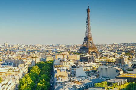 an aerial view of paris with the eiffel tower in the foreground .