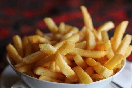 a bowl of french fries is sitting on a table .