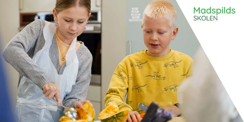 a boy and a girl are cutting a pumpkin with the words madspilds skolen behind them