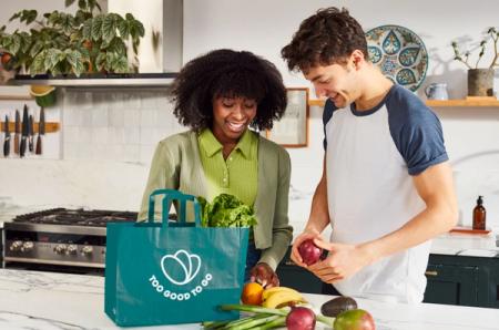 a man and a woman are preparing food in a kitchen .