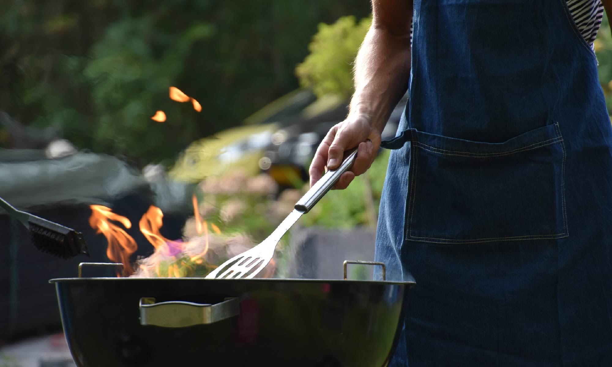 a man is cooking food on a grill with a spatula .