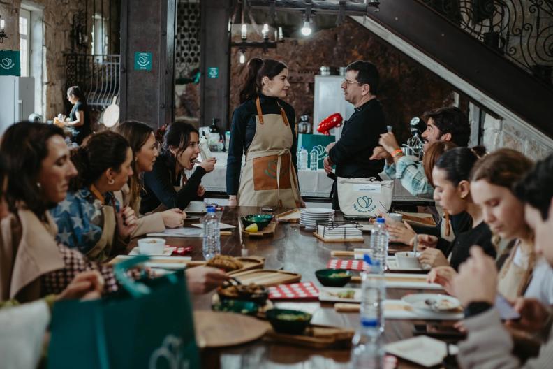 a group of people are sitting at a table eating food Too Good To Go