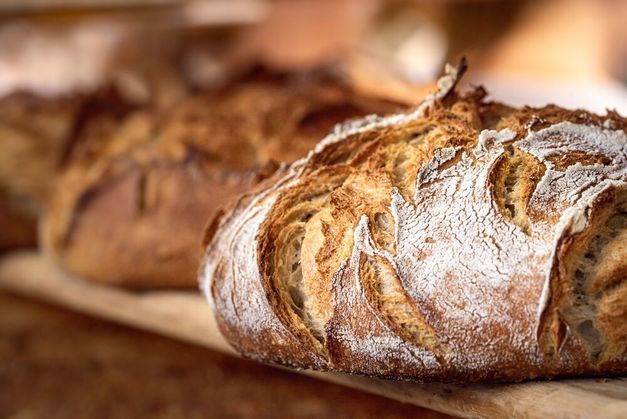 a loaf of bread on a wooden surface