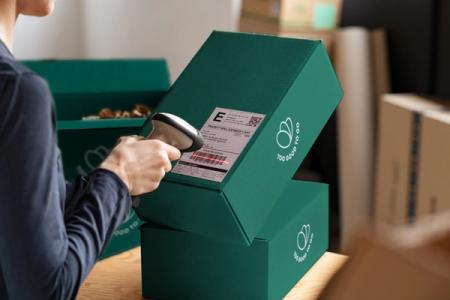 a woman is scanning a package with a barcode scanner .