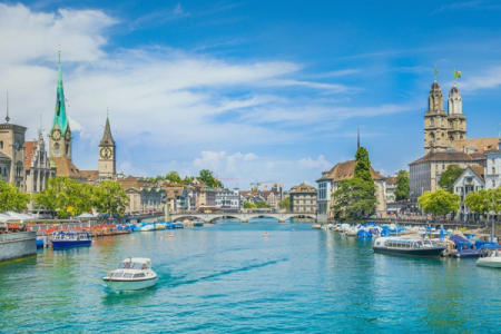 a boat in the water with a clock tower in the background