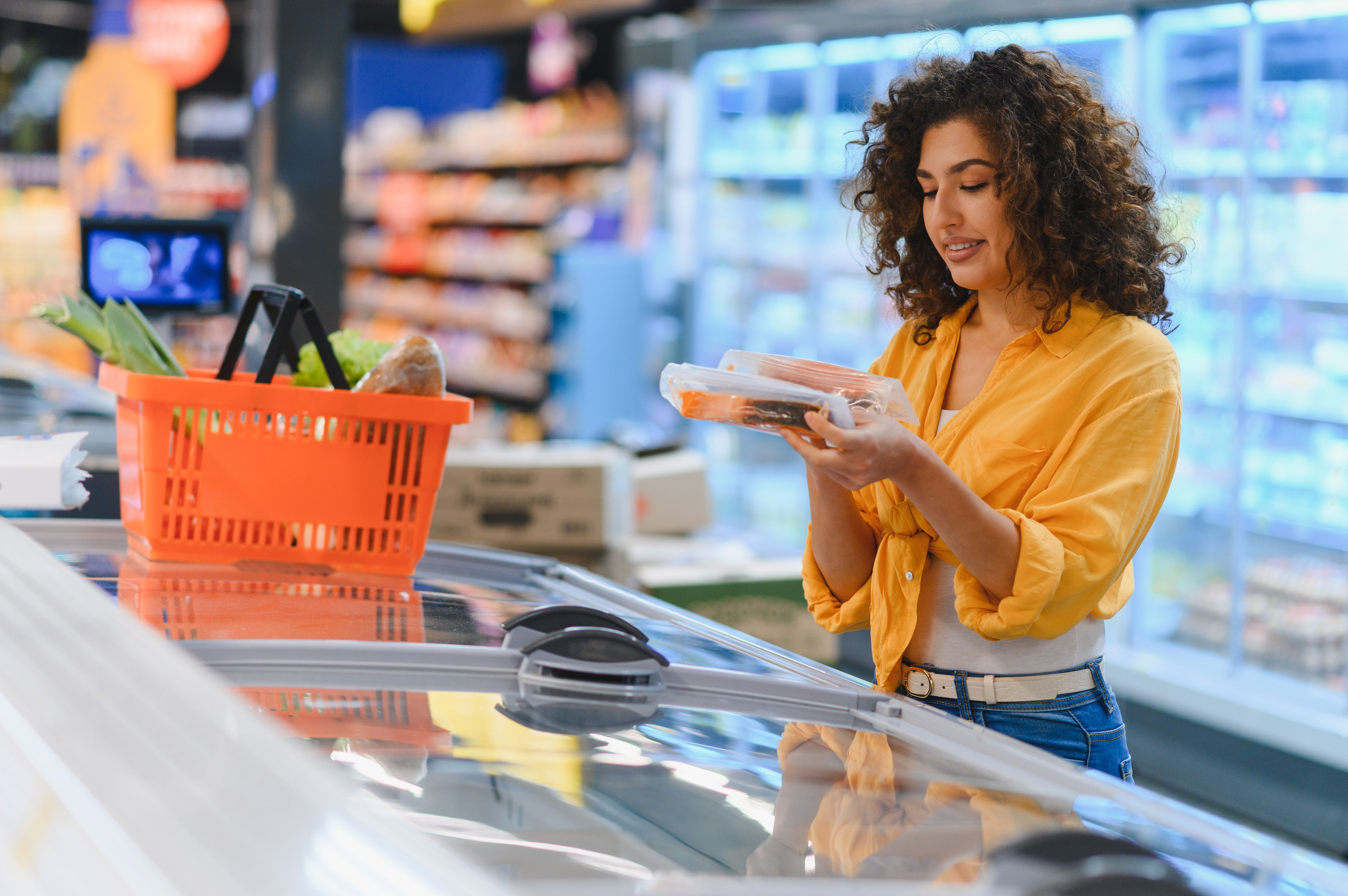 Shopper choosing packaged salmon
