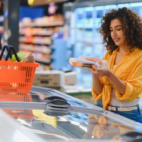 Shopper choosing packaged salmon