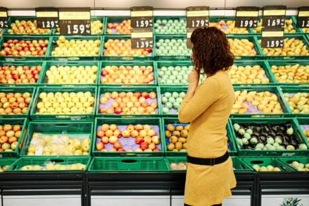 Shopper comparing grocery prices