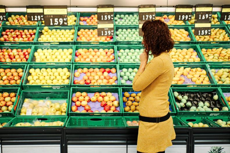 Shopper comparing grocery prices