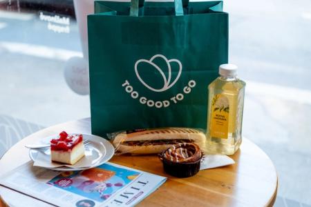 a table with a bag of food and drinks on it .