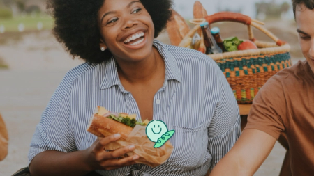 a group of people are having a picnic on the beach .