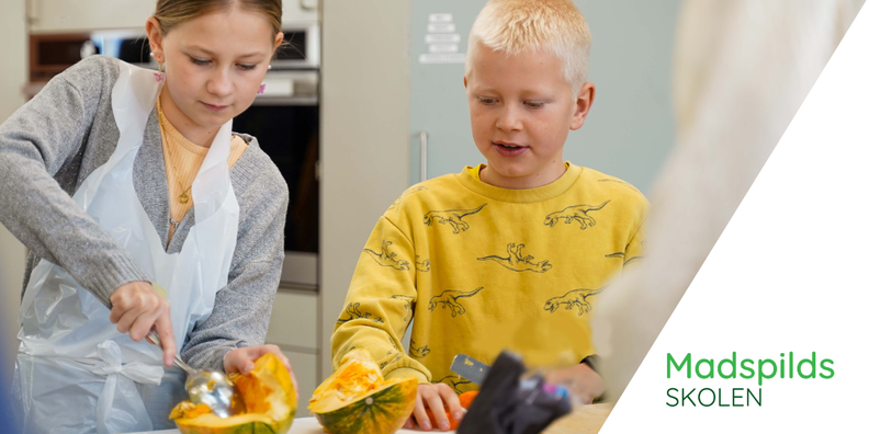 a boy and a girl are cutting a pumpkin with the words madspilds skolen behind them