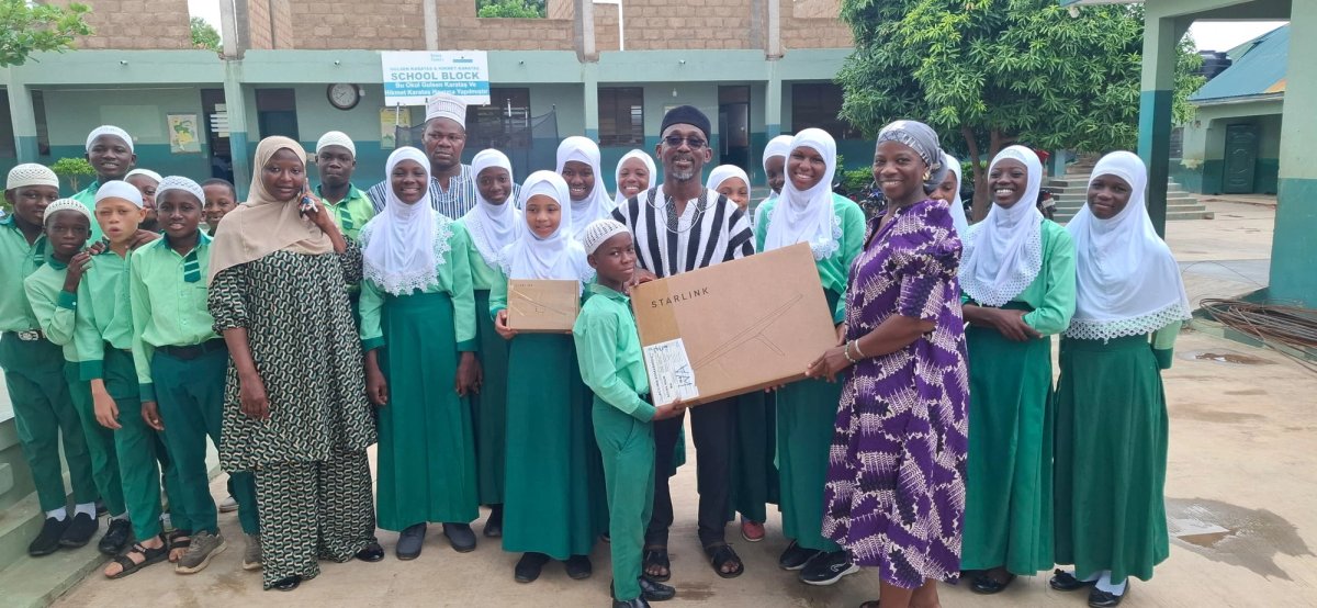 Starlink handover ceremony at school with students in green uniforms, Wa