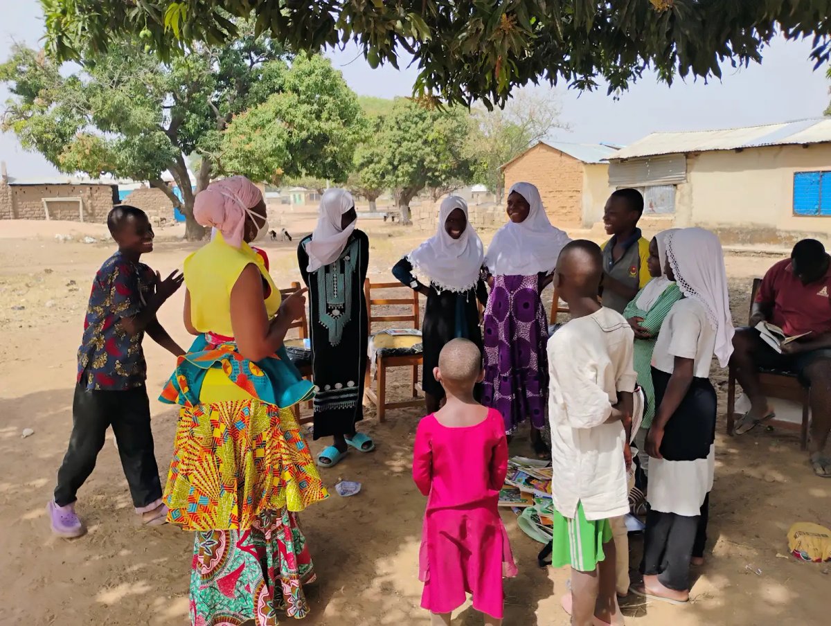 Children and facilitator in an outdoor leadership circle activity