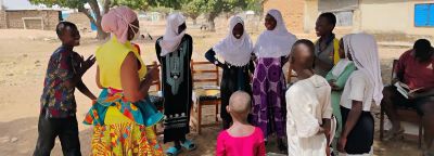 Children in a leadership and safe space circle session outdoors